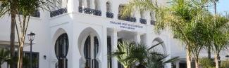 The exterior of main building on U N E's Tangier, Morocco campus surrounded by palm trees